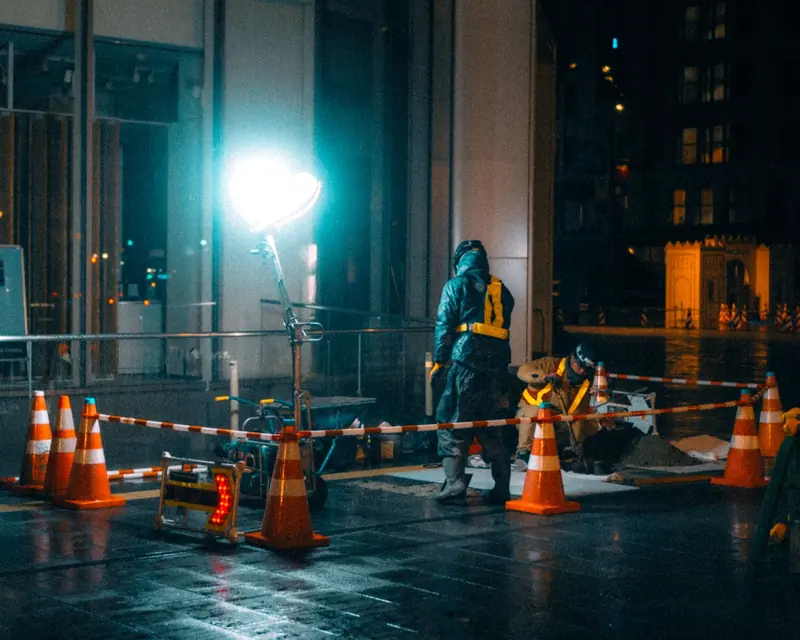 Night emergency work zone with safety cones and portable lighting