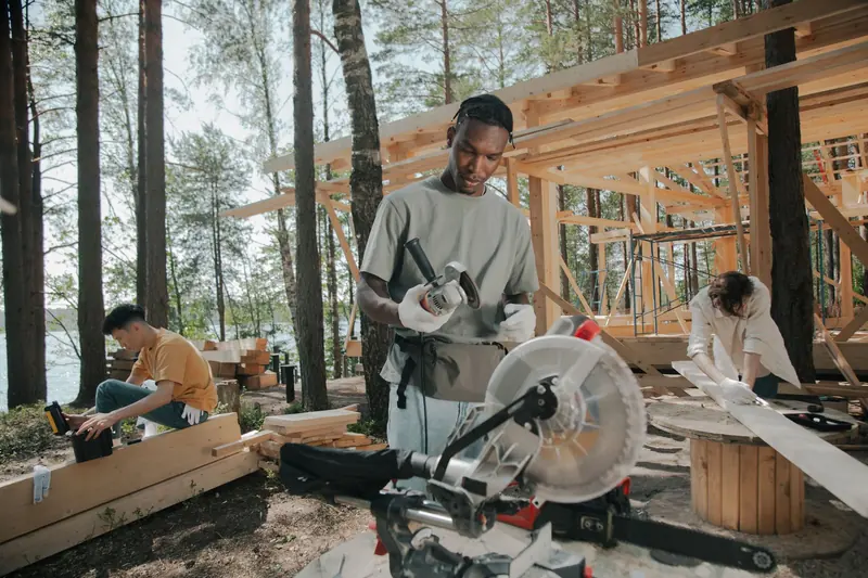 Work crew framing a home project with a miter saw