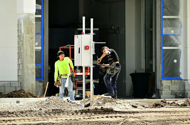 Crew members talking on a city street work site