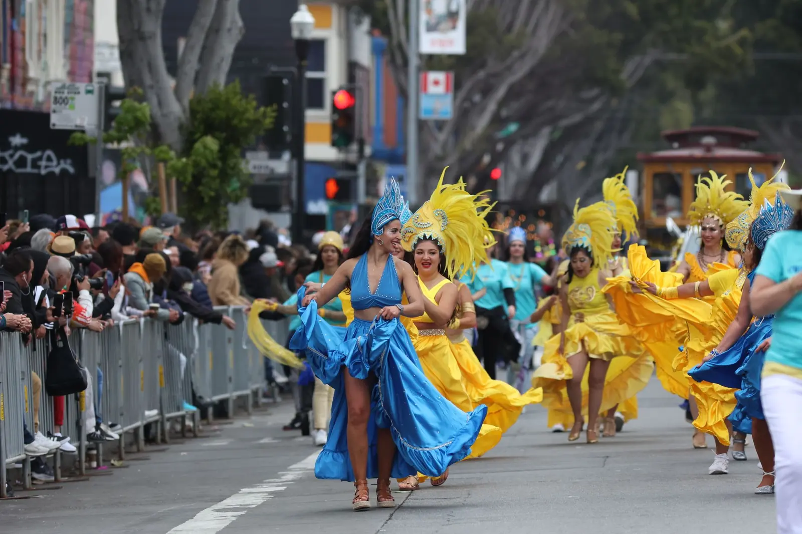 Dancers in bright costumes performing in a San Francisco street festival parade